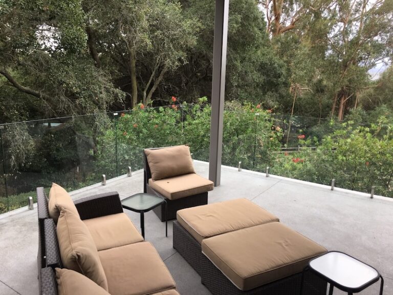 patio deck with frameless glass railings around it in san diego